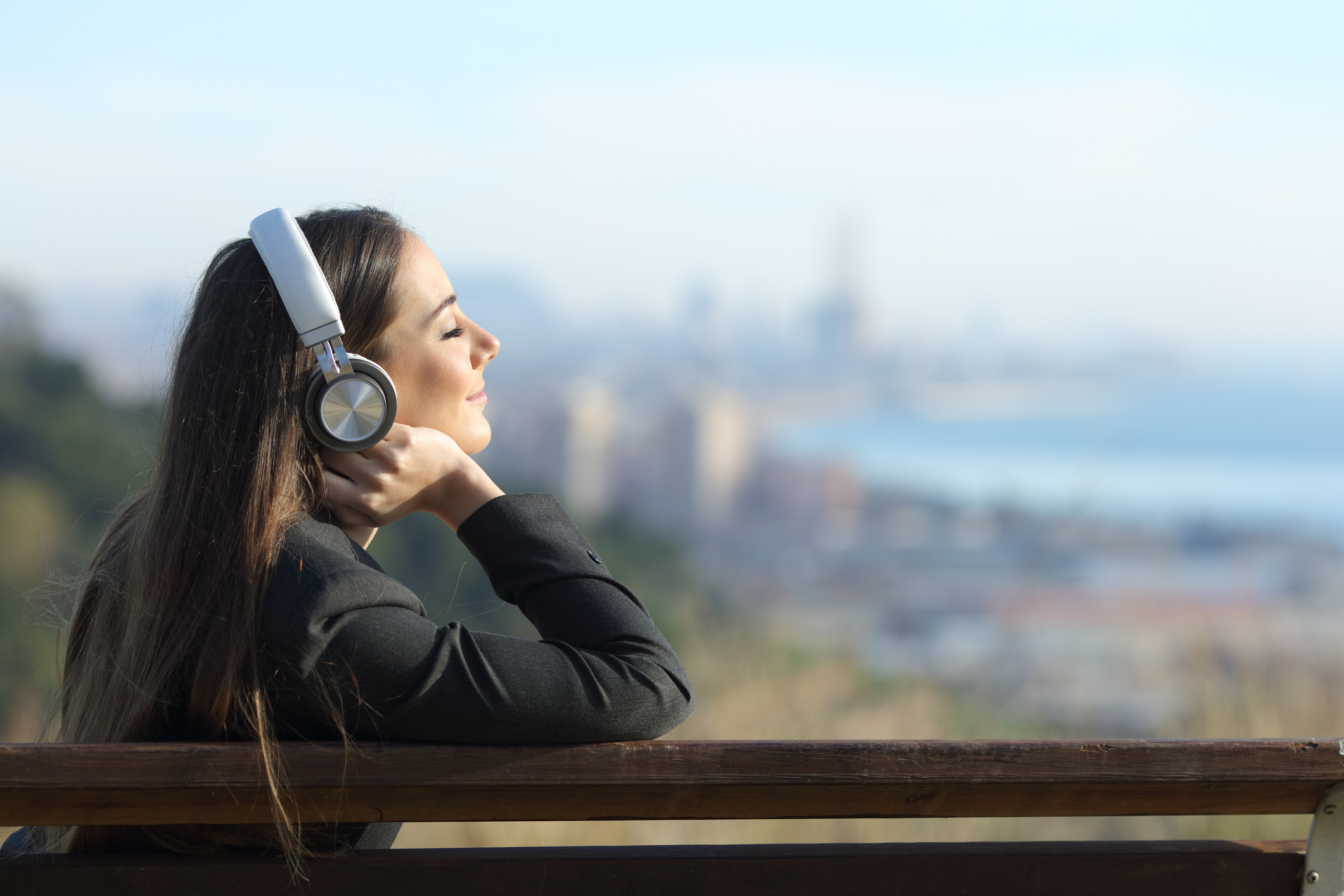 ヘッドホンで音声コンテンツを聞く女性